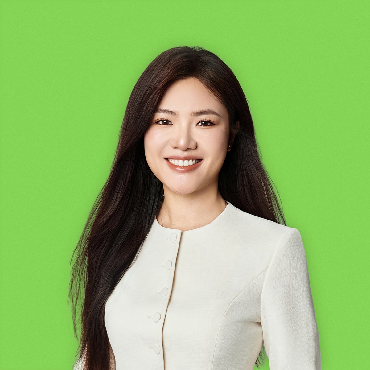 A person with long, straight hair wearing a white, fitted top with a high neckline and button details on the front, standing against a bright green background